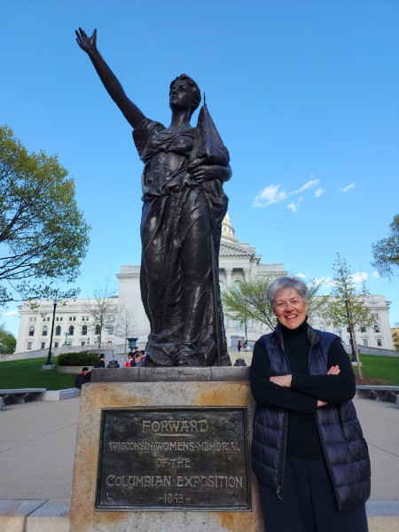 Maria Elena Bisabarros next to the Forward statue at the Wisconsin State Capitol